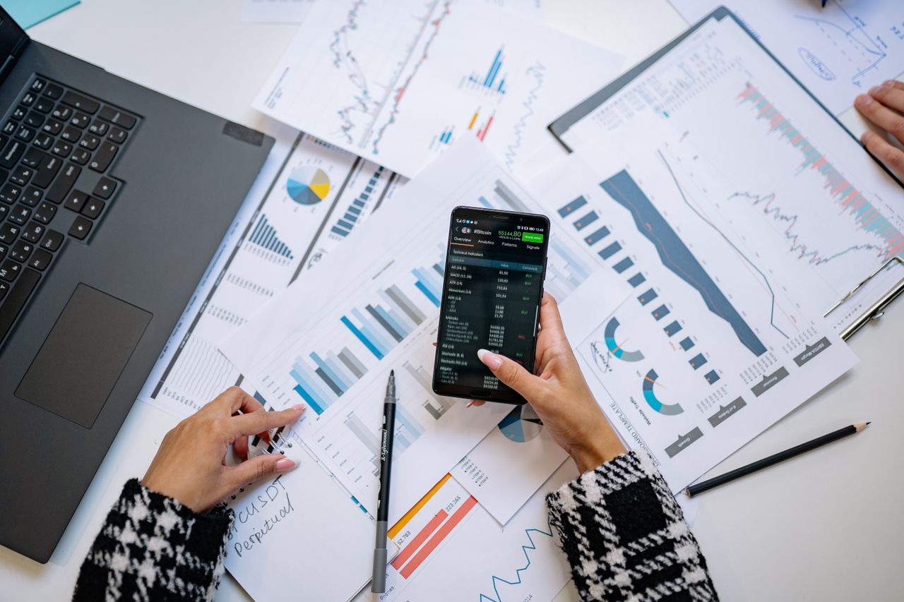 Offerings A top view on charts and smartphone in an office, showcasing data analytics.